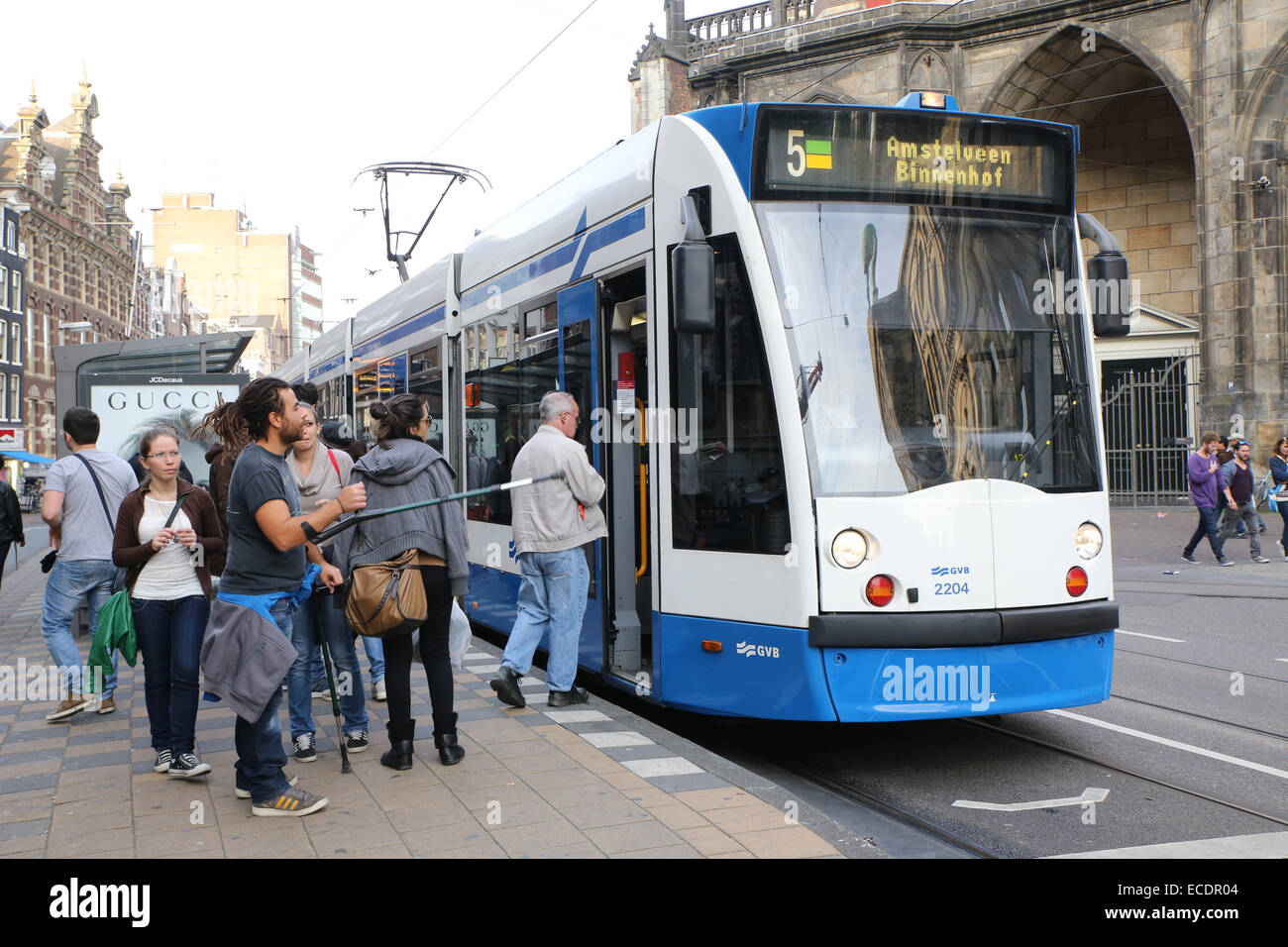 Amsterdam tram with passengers boarding at a city stop